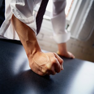 Man hitting table with fist, close-up